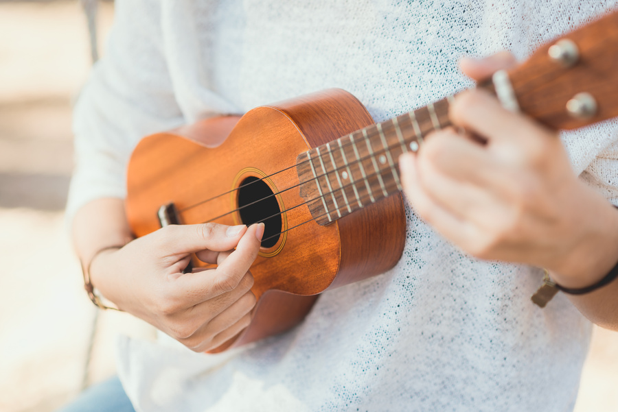 Young woman playing on Ukulele